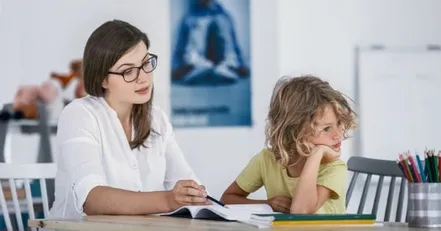 Mother teaching distracted daughter