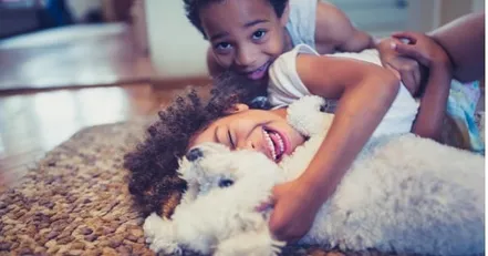 Children playing with their dog