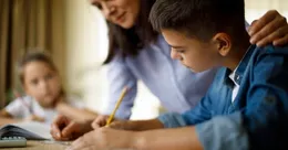 Mother helping her children with homework