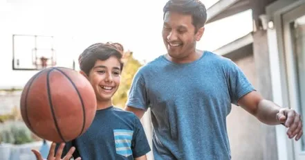 Father playing basketball with his son