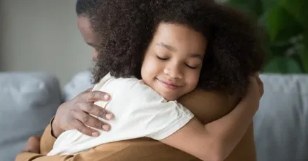 Father hugging daughter