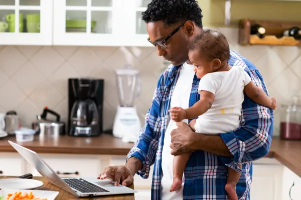 Father reading messages on his laptop