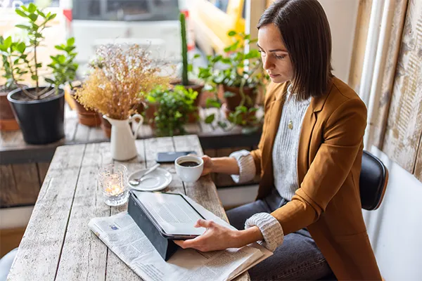 Woman reading an article in a cafe