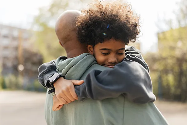 Father hugging son