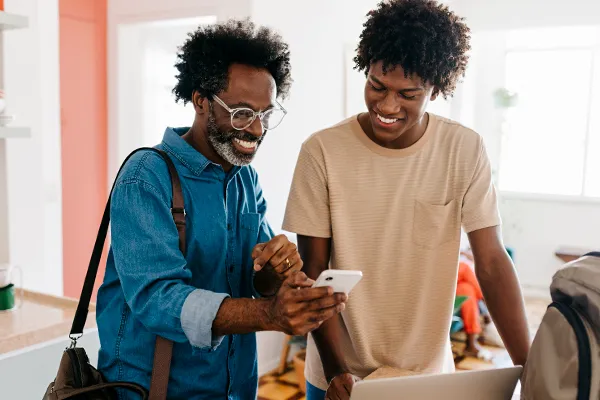 Father showing son his phone