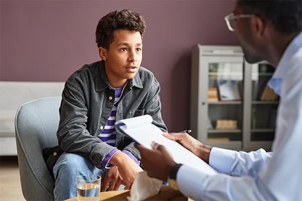 Young boy talking to a therapist