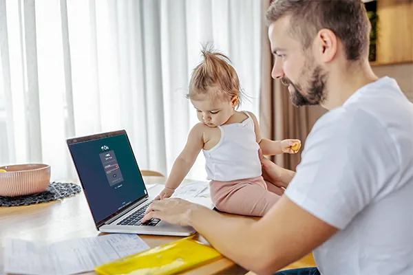 Father typing on his laptop