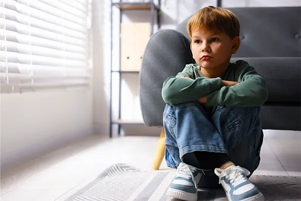 Distant child sitting alone