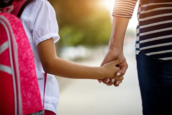 Child holding her mother's hand