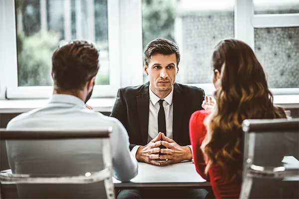 Co-parents talking to a lawyer