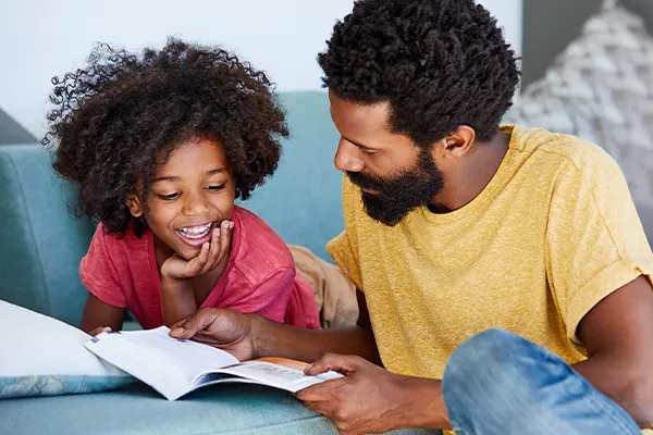 Father reading to his daughter