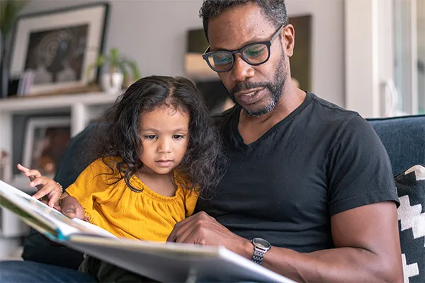 Father reading to daughter