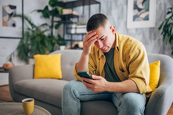 Frustrated man reading texts