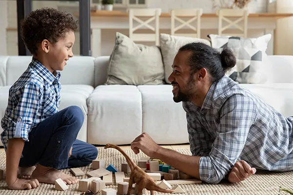Father and son playing with toys