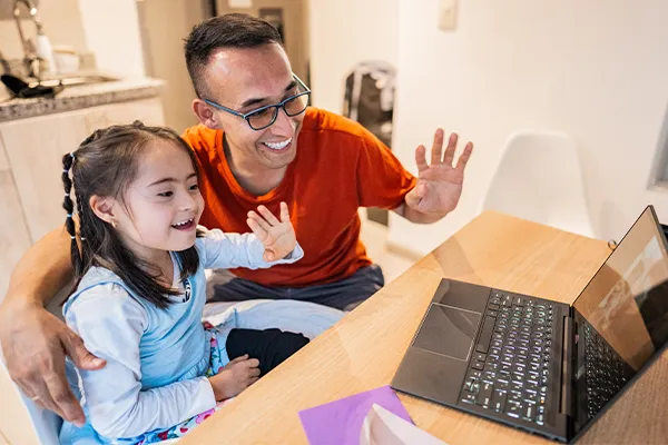 Father and special needs daughter video calling other parent