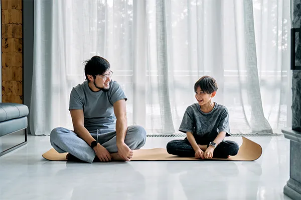 Father and son doing yoga together