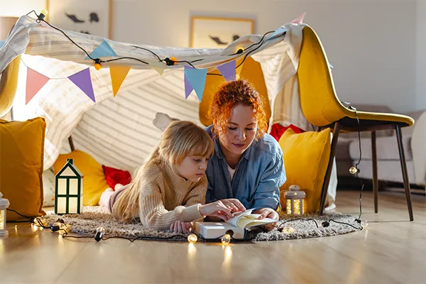 Mother and daughter in play fort