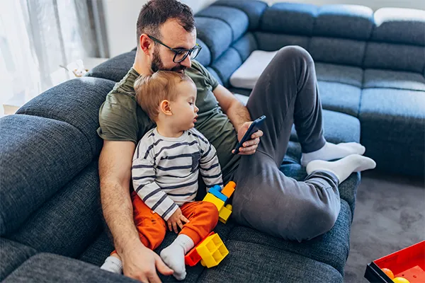 Father texting his co-parent
