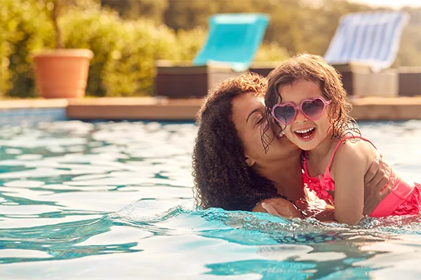 Mother swimming with her daughter