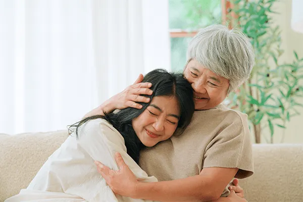 Mother hugging her daughter