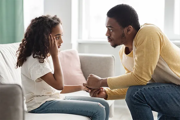 Father consoling daughter