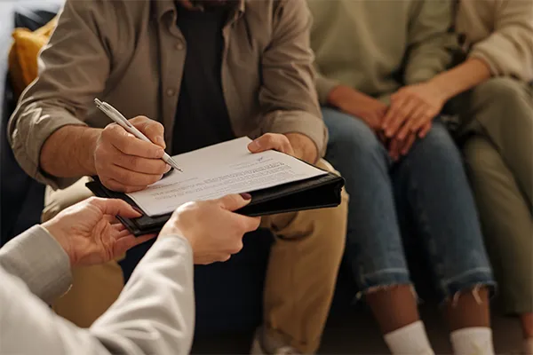 Parents signing a custody agreement