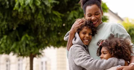 Mother hugging her children