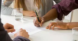 Couple signing a prenup