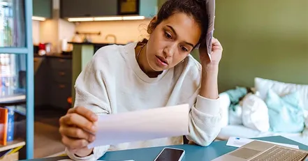 Mother reading through bills