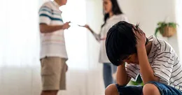 Upset child in from of arguing parents