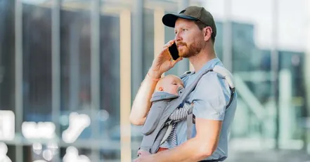 Father with infant on the phone