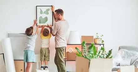 Father unpacking with children