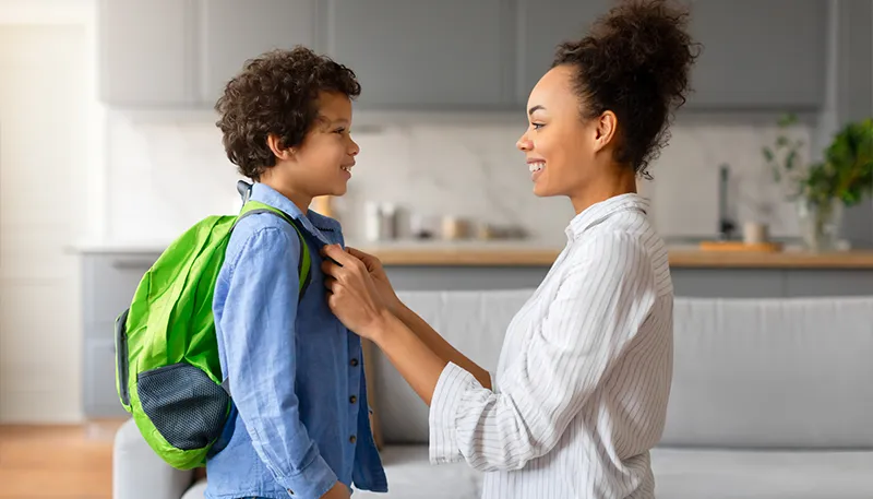 Mother getting son ready for school