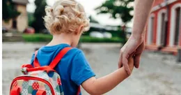 Parents holding child’s hand