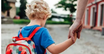 Parents holding child’s hand