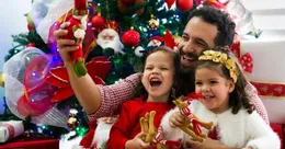 Father and children playing with Christmas toys