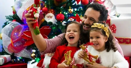 Father and children playing with Christmas toys