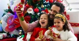 Father and children playing with Christmas toys