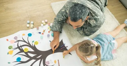 Soldier coloring with his daughter