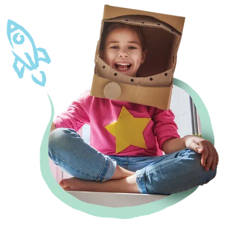 Child sitting playfully with a box on her head