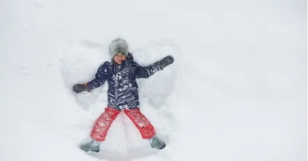 Child making a snow angel