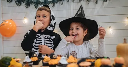 Children eating Halloween cupcakes