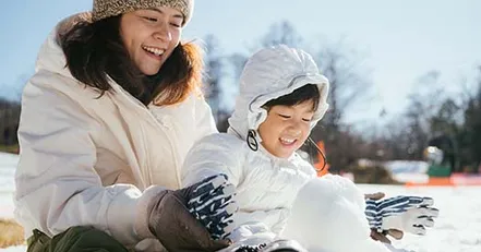 Mother and child playing in snow