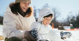 Mother and child playing in snow