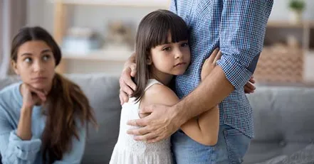 Manipulative parent holding child