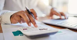 Person working on calculator
