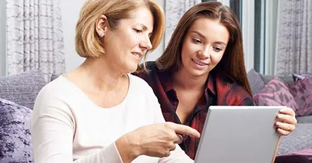 Mother showing daughter a budget