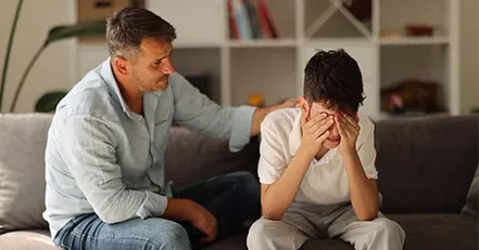 Father consoling his son