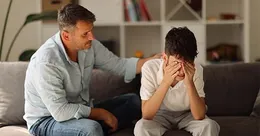 Father consoling his son