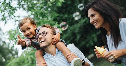 Couple playing with child in a park